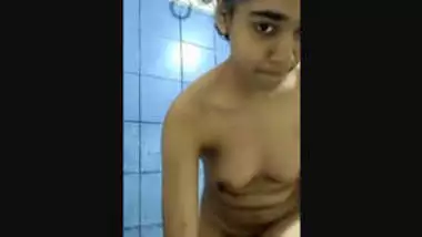 Cute girl undressing in bathroom