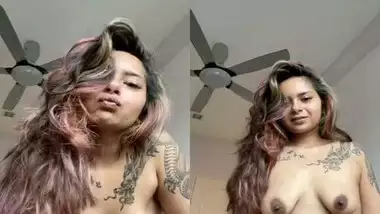 Beautiful tattoed girl showing her boobies
